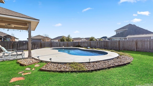 view of swimming pool featuring a patio and a lawn