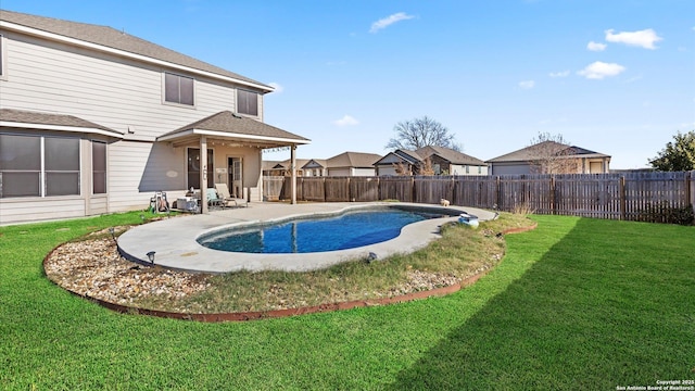 view of swimming pool featuring a yard and a patio