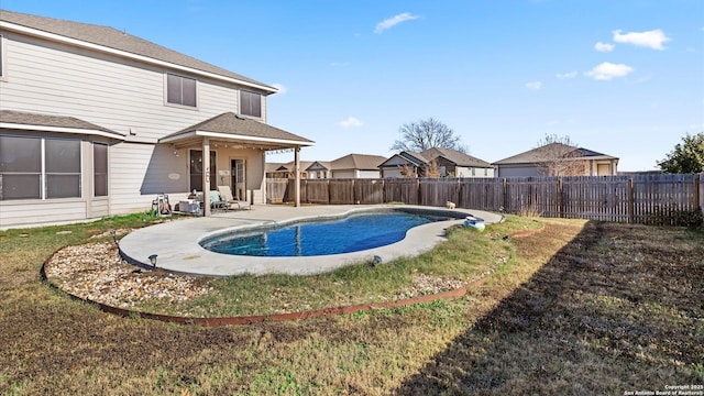 view of pool featuring a lawn and a patio area