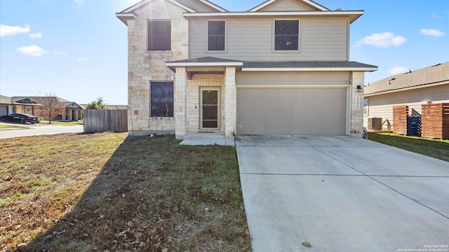 view of front property with a front yard and a garage