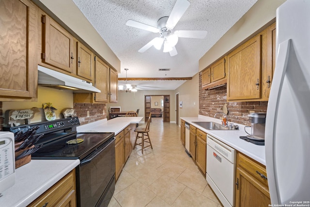 kitchen featuring sink, a textured ceiling, beamed ceiling, white appliances, and hanging light fixtures