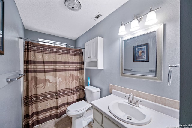 bathroom with toilet, a textured ceiling, tile patterned flooring, a shower with shower curtain, and vanity