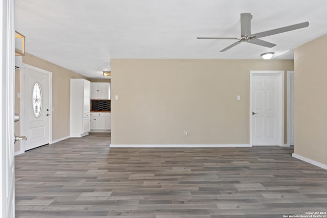 interior space with ceiling fan and dark hardwood / wood-style floors