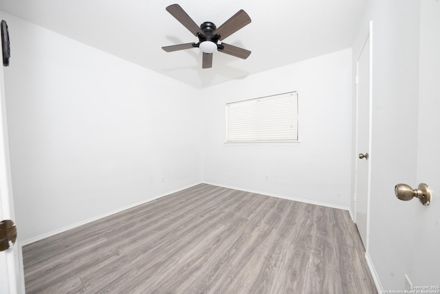 empty room featuring ceiling fan and light hardwood / wood-style flooring