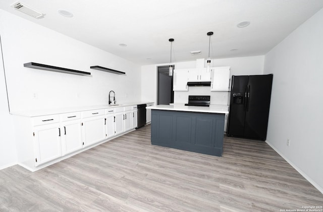 kitchen with black appliances, pendant lighting, a kitchen island, sink, and white cabinetry