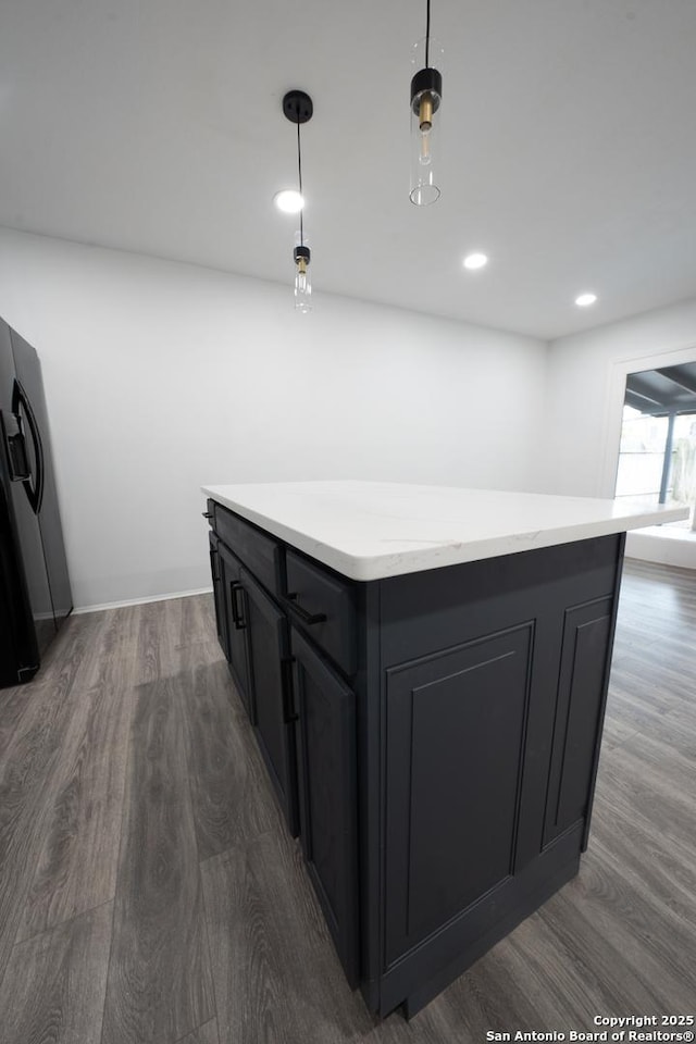 bar featuring dark wood-type flooring and decorative light fixtures