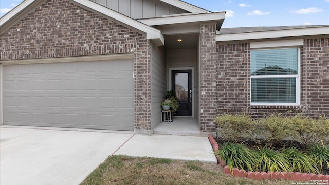 doorway to property with a garage