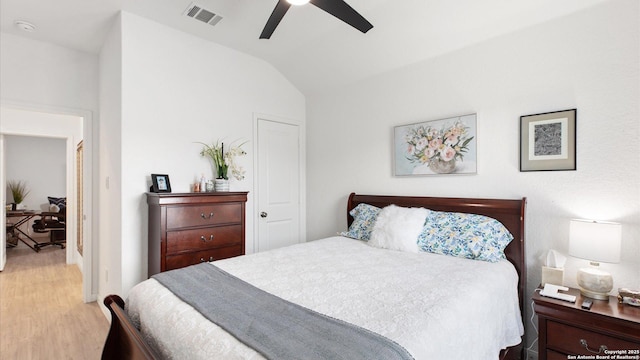 bedroom featuring light hardwood / wood-style floors, ceiling fan, and vaulted ceiling