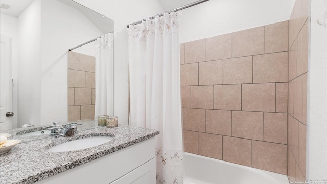 bathroom featuring vanity and shower / bath combination with curtain