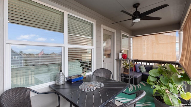 sunroom featuring ceiling fan