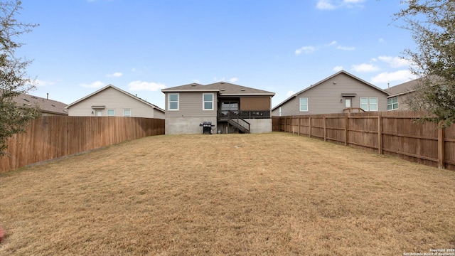 rear view of house featuring a lawn