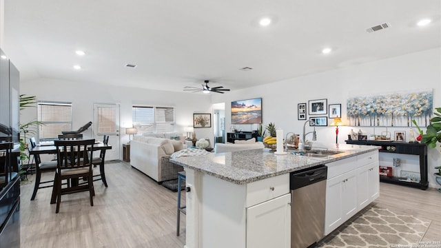 kitchen featuring dishwasher, a center island with sink, white cabinets, ceiling fan, and sink