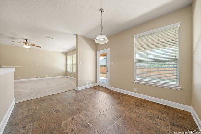 interior space featuring a textured ceiling and ceiling fan