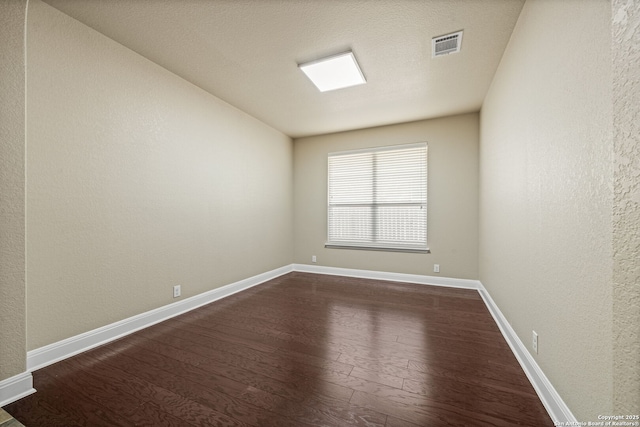 spare room featuring dark hardwood / wood-style floors