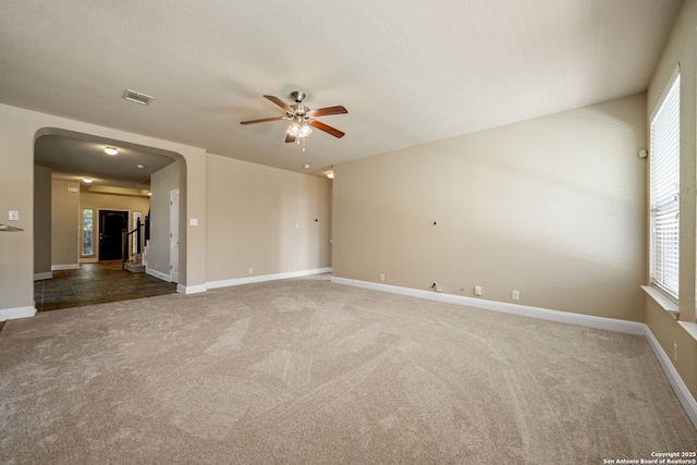 empty room with ceiling fan and carpet