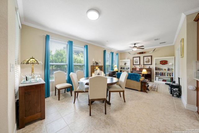 dining area with ornamental molding and ceiling fan