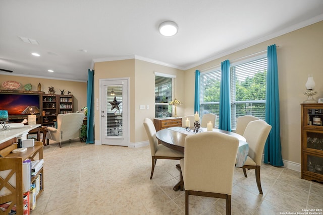 dining area with ornamental molding and light tile patterned floors