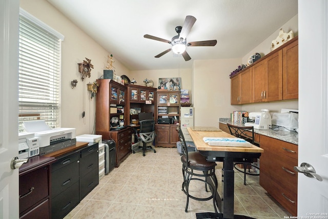 home office with ceiling fan and light tile patterned floors