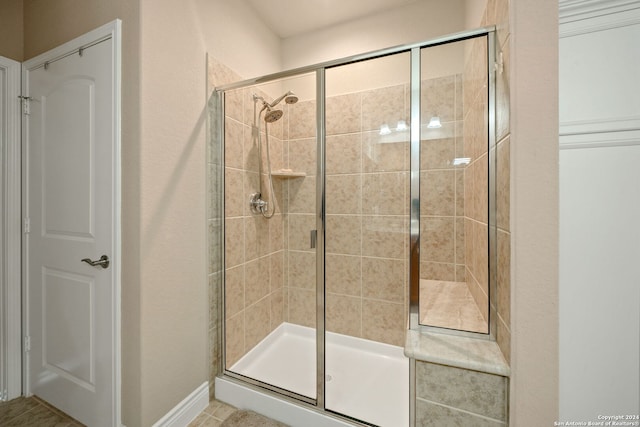 bathroom with tile patterned flooring and an enclosed shower