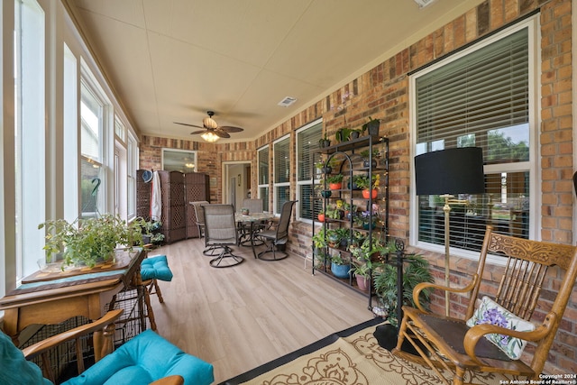 sunroom / solarium featuring ceiling fan