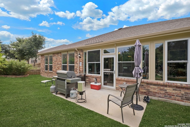 back of property featuring a patio and a lawn