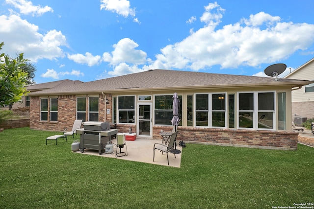 rear view of property with central air condition unit, a patio area, and a yard