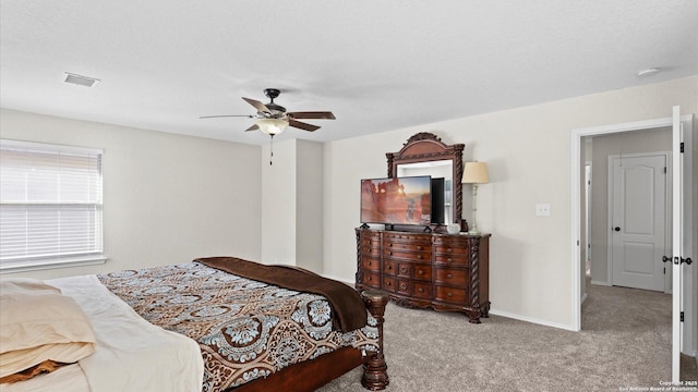 bedroom with ceiling fan and light carpet