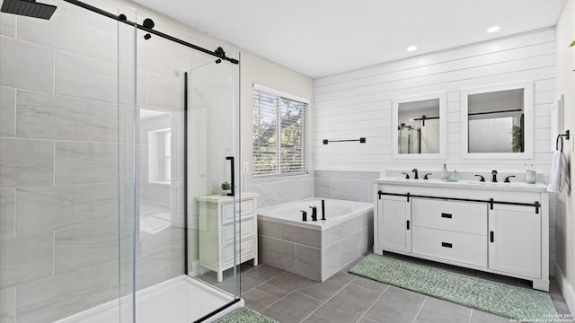 bathroom featuring independent shower and bath, tile patterned floors, and vanity