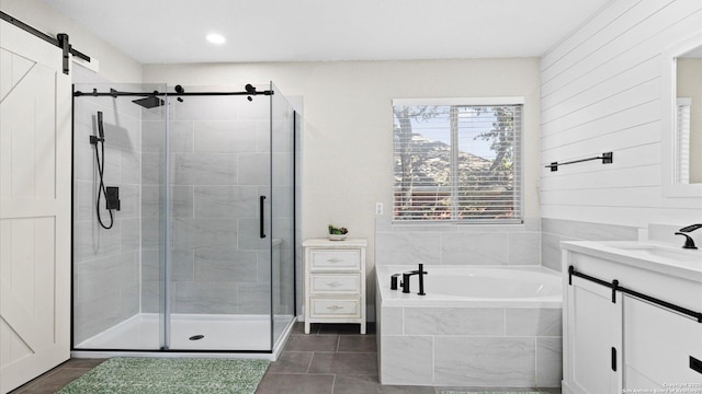 bathroom featuring tile patterned flooring, independent shower and bath, and vanity