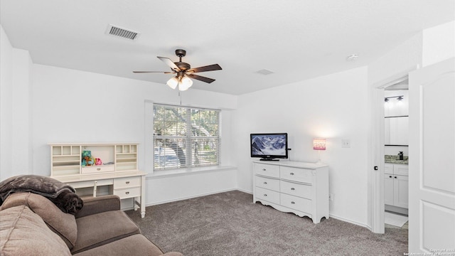 living room featuring ceiling fan and carpet