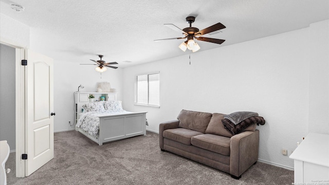 bedroom with ceiling fan, light colored carpet, and a textured ceiling