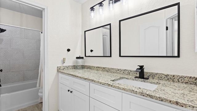 full bathroom with toilet, shower / tub combo, vanity, and hardwood / wood-style floors