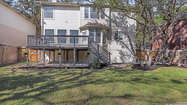 rear view of property with a lawn and a deck