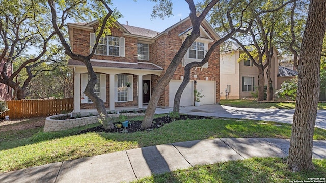 view of front of property featuring a front yard and a garage