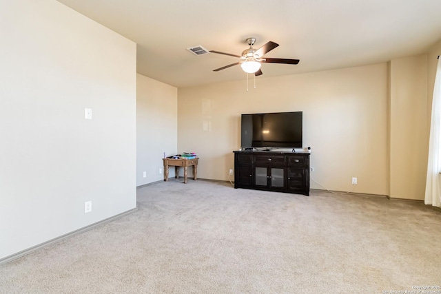 unfurnished living room featuring ceiling fan and light colored carpet