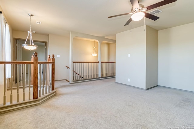 spare room featuring ceiling fan and carpet flooring