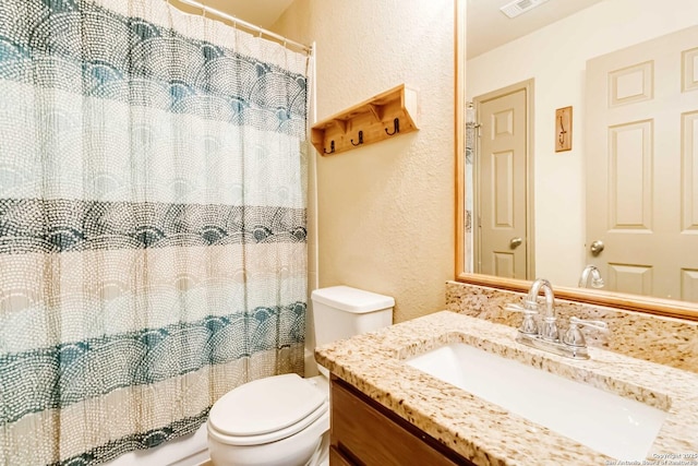 bathroom with toilet, a shower with shower curtain, and vanity