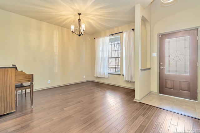 entryway featuring a notable chandelier and hardwood / wood-style floors