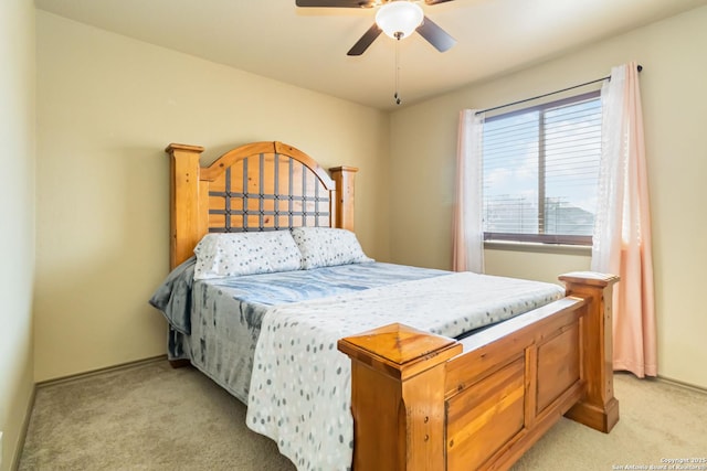 bedroom with ceiling fan and light carpet