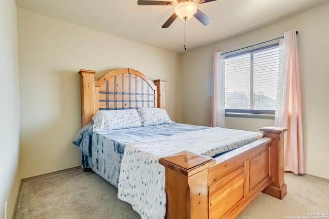 bedroom with ceiling fan and light carpet