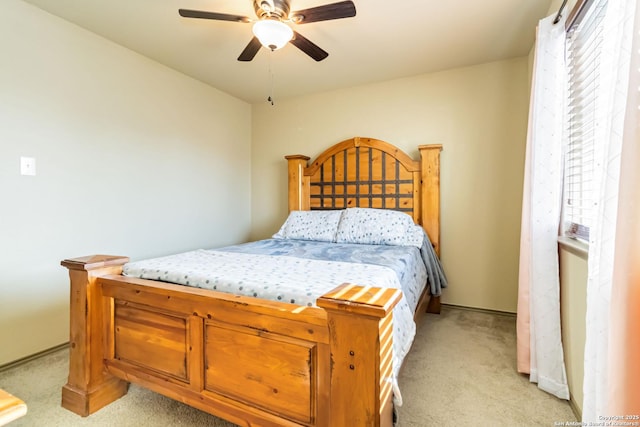 bedroom featuring light colored carpet and ceiling fan