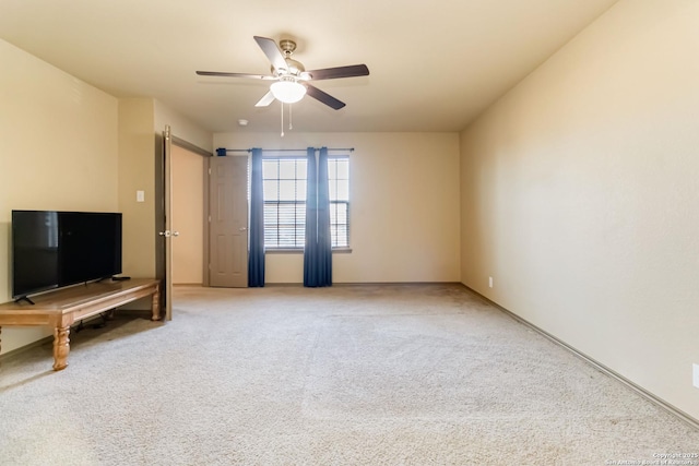 unfurnished living room with carpet floors and ceiling fan