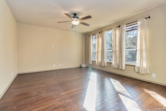 unfurnished room with dark hardwood / wood-style flooring and ceiling fan