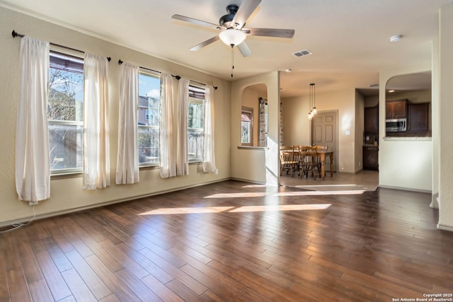 unfurnished room featuring ceiling fan and dark hardwood / wood-style flooring