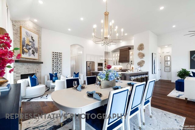435 Nash, New Braunfels, TX 78130 - dining room featuring ceiling fan with notable chandelier, a fireplace, sink, and dark hardwood / wood-style floors