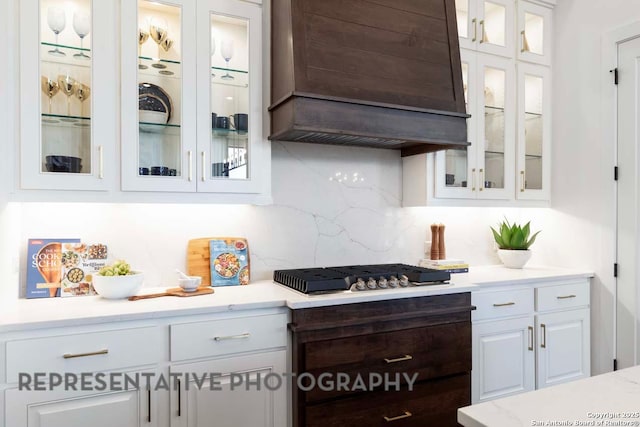 435 Nash, New Braunfels, TX 78130 - kitchen featuring backsplash, stainless steel gas cooktop, custom exhaust hood, and white cabinetry