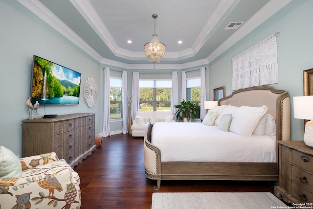 bedroom with a raised ceiling, an inviting chandelier, ornamental molding, and dark wood-type flooring