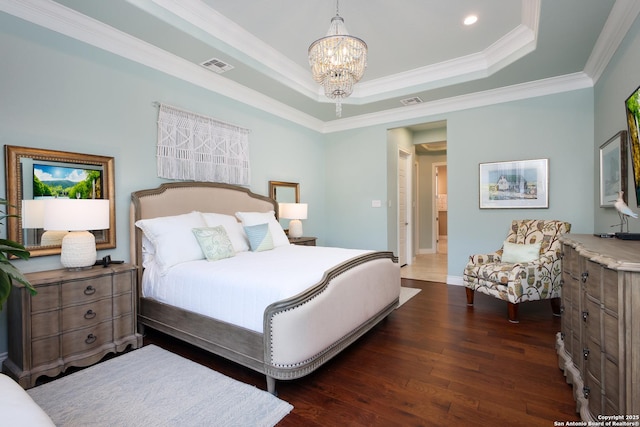 bedroom featuring a notable chandelier, crown molding, dark hardwood / wood-style floors, and a tray ceiling