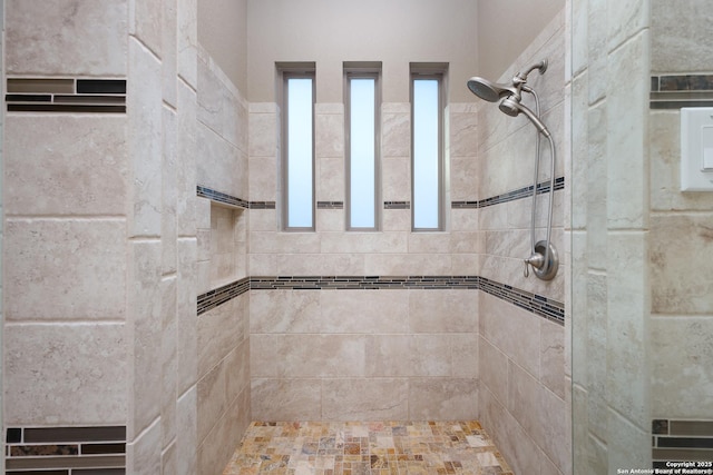 bathroom with a tile shower