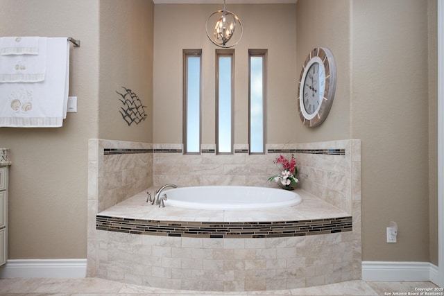 bathroom featuring a relaxing tiled tub and a notable chandelier